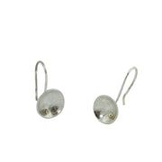 Eco silver cup hook earrings. They feature a small 9ct gold ball at the bottom half of the cups. They are available in two different textures, an oval pebble texture and a stripe texture.