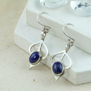 Silver drop flower earrings. Featuring a flower shape with open leaves leading to a Lapis gemstone bud.