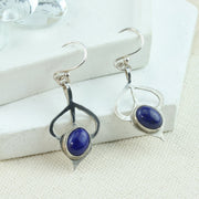 Silver drop flower earrings. Featuring a flower shape with open leaves leading to a Lapis gemstone bud.