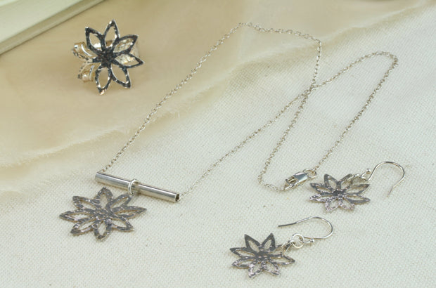 Set of silver flower with sharp leaves jewellery with the adjustable statement ring, pendant necklace and hook earrings.
