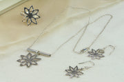 Set of silver flower with sharp leaves jewellery with the adjustable statement ring, pendant necklace and hook earrings.