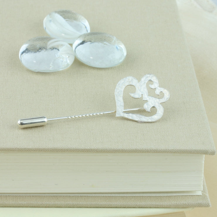 Silver hearts pin. A brooch or hat pin featuring a double heart shape, with one smaller heart sitting like a crown on top of the larger heart shape. Gorgeous on a hat, scarf, or jacket.