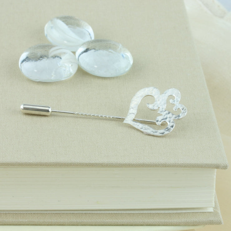 Silver hearts pin. A brooch or hat pin featuring a double heart shape, with one smaller heart sitting like a crown on top of the larger heart shape. Gorgeous on a hat, scarf, or jacket.