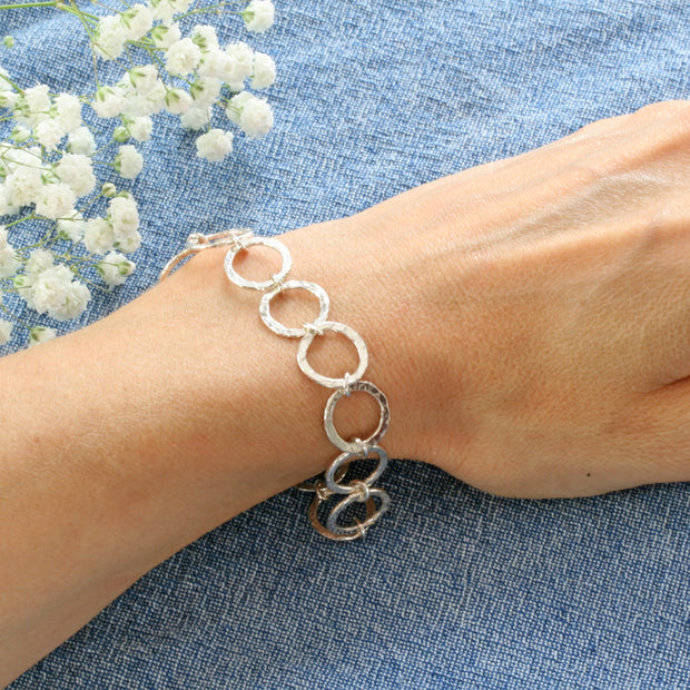Silver hoop bracelet with a hammered texture for added sparkle.