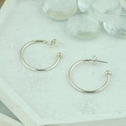 Silver hoop earrings with briolette gemstones. Classic hoop earrings, featuring a shiny polished finish.