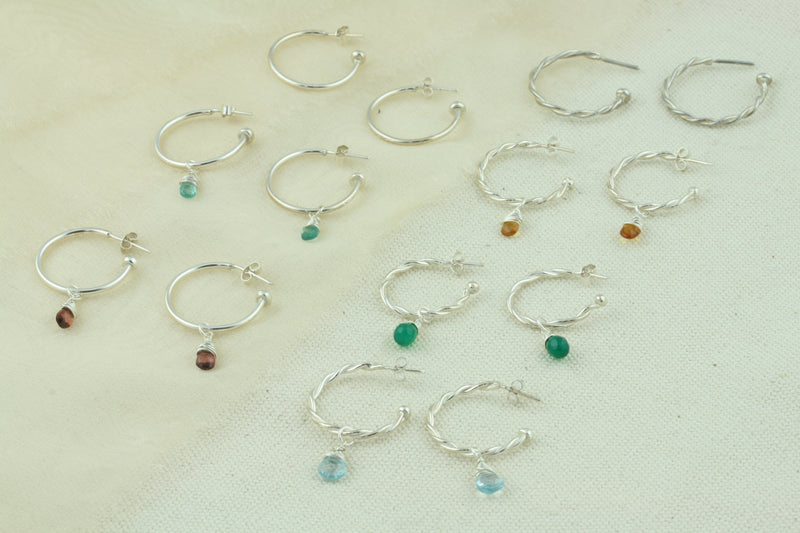 Silver hoop earrings with briolette gemstones. Classic hoop earrings and hoop earrings with two twisted wires. All featuring a shiny polished finish. Shown here on their own and combined with a variety of gemstones set in a briolette setting. Available as sets as well as well as separate gemstones to add to your collection.