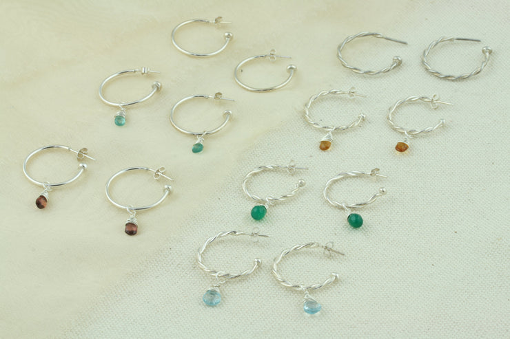 Silver hoop earrings with briolette gemstones. Classic hoop earrings and hoop earrings with two twisted wires. All featuring a shiny polished finish. Shown here on their own and combined with a variety of gemstones set in a briolette setting. Available as sets as well as well as separate gemstones to add to your collection.