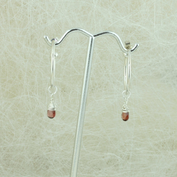 Silver hoop earrings with briolette gemstones. Classic hoop earrings, featuring a shiny polished finish. Shown here on combined with the Garnet briolette gemstones.  Separate gemstones to add to your collection are available as well.