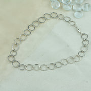 Silver hoop necklace with hammered hoops that sparkle in the light. Four hoops in the middle are made from square silver wire.
