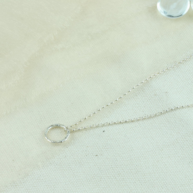 Eco silver hoop shiny pendant necklace with a hammered texture making the hoop sparkle.