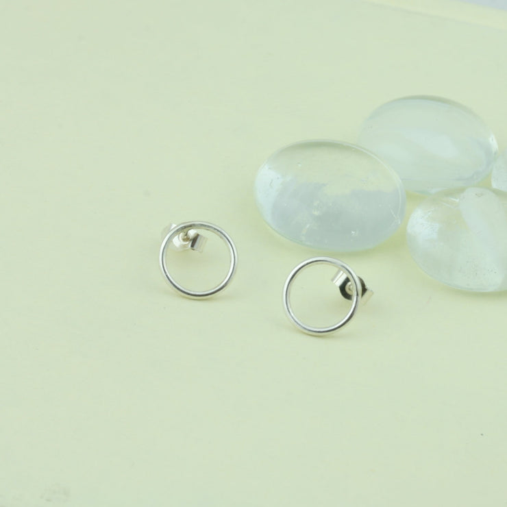 Small silver hoop stud earrings, approximately 6mm in diameter. They have a shiny silver finish and are made from eco silver.