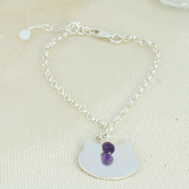 Silver personalised charm bracelet with a cat charm that can be personalised with a word, name, initials or symbols of your choosing. The bracelet features an extender chain so the bracelet fits between 16.5 and 21cm. The charm is made using eco silver. This particular bracelet also features an Amethyst briolette gemstone.