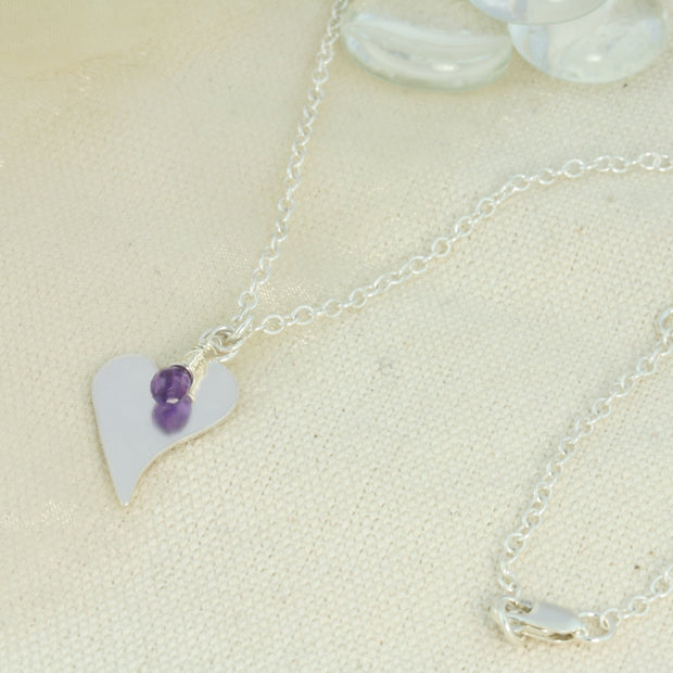 Silver personalised heart pendant necklace with Amethyst briolette gemstone.  The heart is approximately 2 x 1.5cm in diameter  with a larger version of 2.5 x 2cm available as well and can be personalised with a word, initials, letter or symbols. The briolette gemstones is attached to the same jump ring as the pendant, so they sit together. The necklace can be fastened at three different lengths at 40cm, 45cm and 50cm.