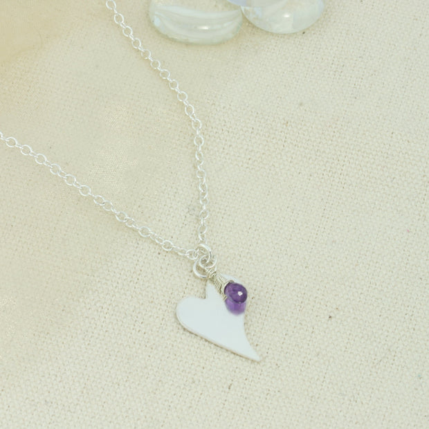 Silver personalised heart pendant necklace with Amethyst briolette gemstone.  The heart is approximately 2 x 1.5 cm in diameter  with a larger version of 1.5 x 2cm available as well and can be personalised with a word, initials, letter or symbols. The briolette gemstones is attached to the same jump ring as the pendant, so they sit together. The necklace can be fastened at three different lengths at 40cm, 45cm and 50cm.
