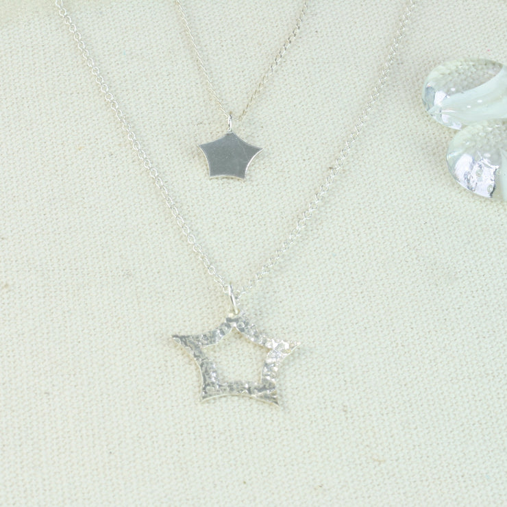 Silver pendant set with the rounded star and quirky star pendant necklaces.