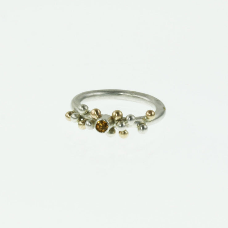 Eco silver ring with silver and 9ct gold balls at the top, with a Citrine gemstone in in the middle. The gemstone is 3mm in diameter and the ring has a matte finish.