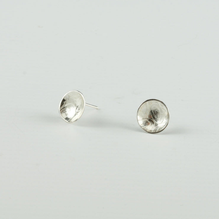 Eco silver cups studs with a pebble texture.  The earrings have a shiny finish.