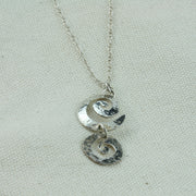 Silver opera necklace featuring 6 swirls with a hammered sparkly finish. The two bottom swirls form a small drop to add some detail. The swirls are connected by trace chain.