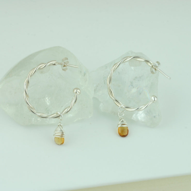 Silver hoop earrings featuring two twisted wires, with briolette gemstones. Classic hoop earrings, featuring a shiny polished finish. Shown here on combined with the Citrine briolette gemstones. Separate gemstones to add to your collection are available as well.