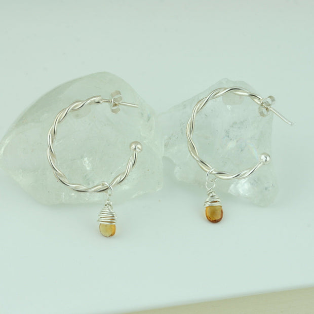 Silver hoop earrings with briolette gemstones. Hoop earrings made with two twisted silver wires, featuring a shiny polished finish. Featured here with Citrine briolette gemstones.