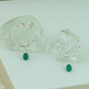 Silver hoop earrings with briolette gemstones. Hoop earrings made with two twisted silver wires, featuring a shiny polished finish. Featured here with Green Onyx briolette gemstones.