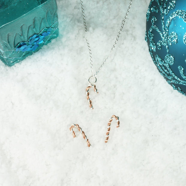 Silver and copper stud earrings. Silver and copper wire has been twisted around each other and shaped into a candy cane shape. Available in two sizes, seen here with the matching pendant necklace.