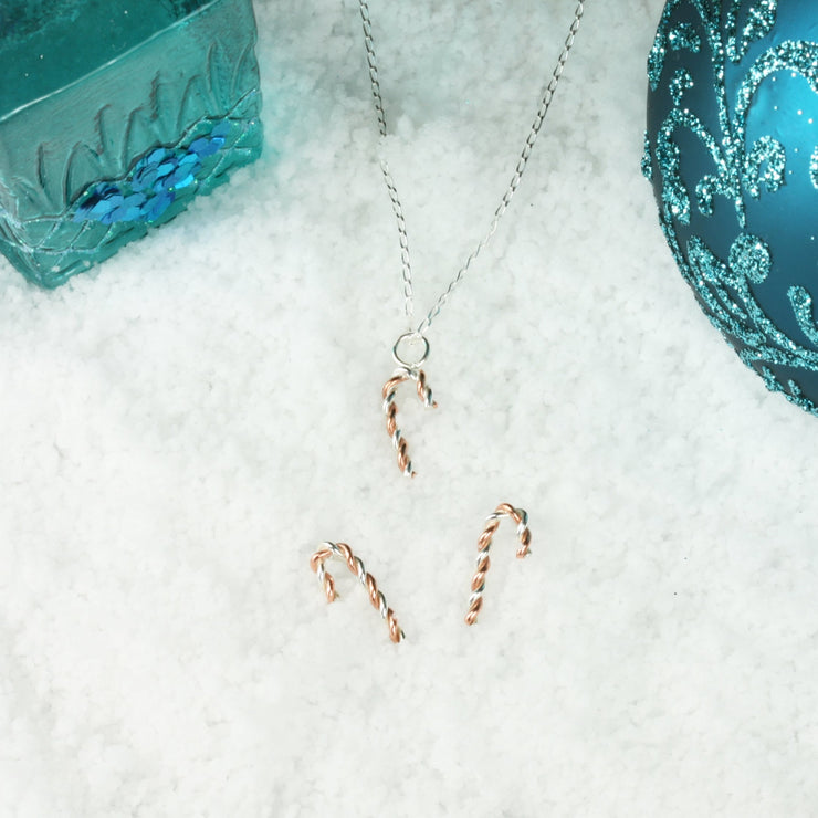 Silver and copper pendant necklace featuring a candy cane shape made from copper and silver wire that has been twisted around each other. Available in two sizes and seen here with the matching stud earrings.