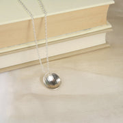Eco silver pendant necklace with a stripe texture and mirror finish. 