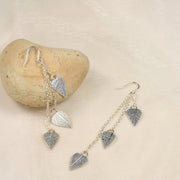 Eco silver leaves drop earings featuring three small leaves at different lengths dropped from a hook earring. The front has a real leaf texture and the back has a mirror finish. The eaf texture lets the leaves sparkle and shimmer in any light.