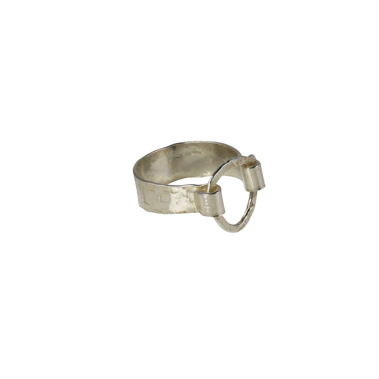 Silver triangle ring. A triangle shape is held in place by the folded sides of the band of the ring. Both the ring and the triangle have a hammered polished finish. making the whole ring sparkle.
